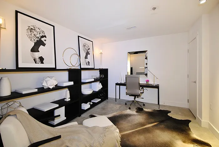 Chic home office space featuring modern artwork, stylish shelving, sleek desk, and elegant decor.