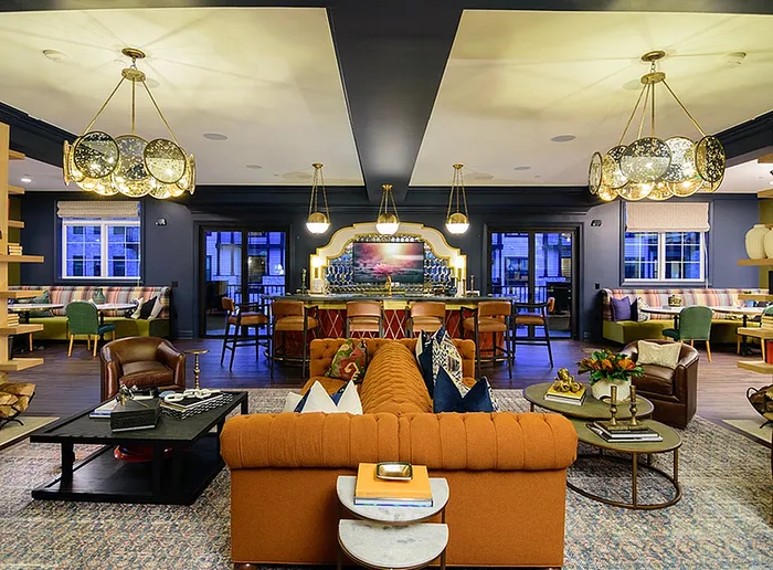 Luxurious open-concept living space featuring a stylish bar area, plush seating, and elegant lighting perfect for entertaining.