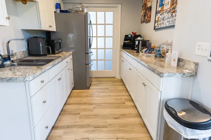 Inviting modern kitchen with sleek countertops, stylish white cabinets, and stainless steel appliances.