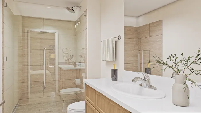 Elegant bathroom with a modern glass shower, sleek vanity, and stylish decor, featuring a warm, inviting atmosphere.