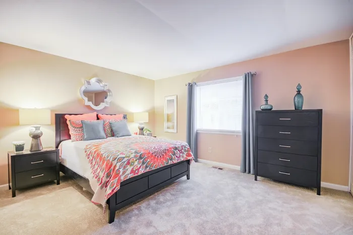 Spacious bedroom at Chateau de Ville with natural lighting.
