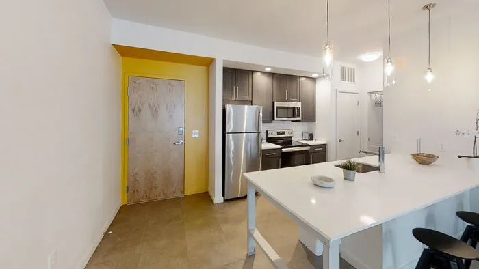 MARQ modern kitchen with sleek stainless steel appliances, stylish pendant lighting, and a chic island countertop, perfect for entertaining and culinary creativity.