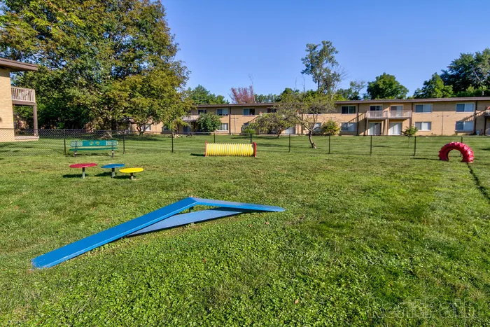 Dog Park with vibrant outdoor play area surrounded by lush greenery, ideal for families and pet owners.