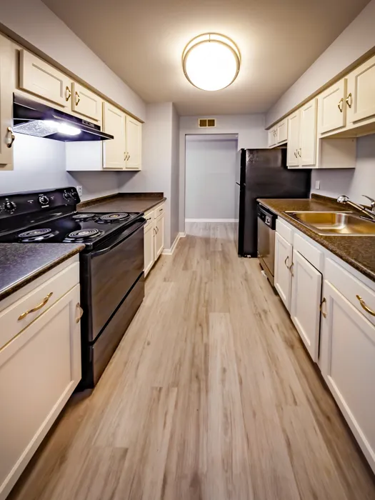 Charming galley kitchen with modern appliances, sleek cabinets, and elegant flooring perfect for culinary adventures.