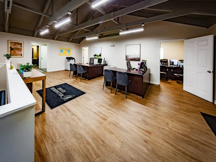 Modern leasing office space with sleek wooden flooring..
