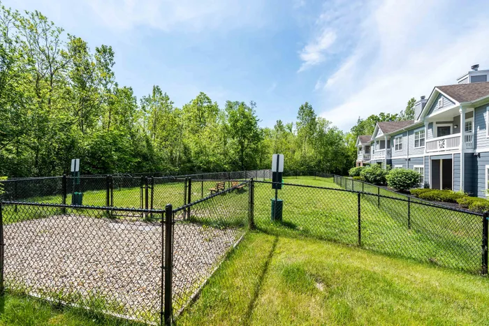 Fenced-in pet area offering serene living with nature views.