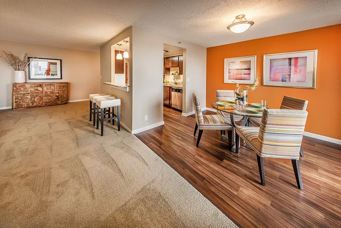 Bright dining area alongside a cozy living space, featuring elegant lighting.