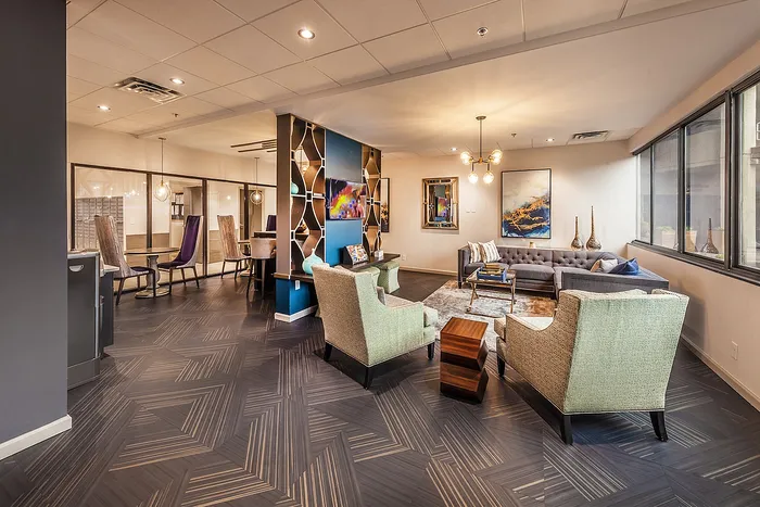 Sophisticated open-concept lounge with elegant seating, artistic decor, and modern lighting, perfect for stylish gatherings.