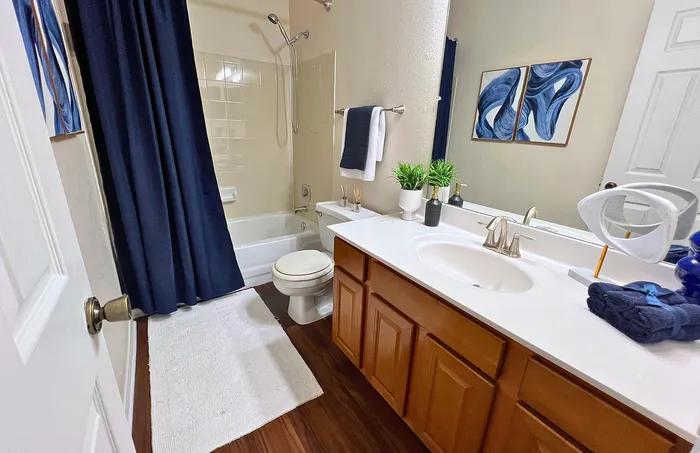 Modern bathroom with sleek wooden cabinets and elegant white countertop creating a fresh and inviting atmosphere.