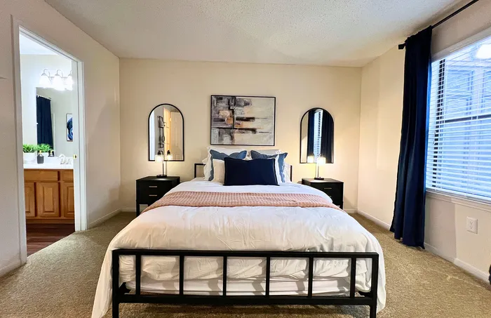 Inviting bedroom and ensuite bathroom, bathed in natural light for a serene retreat.