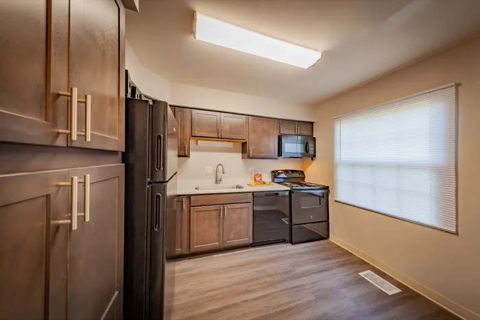 Elegant kitchen with dark wood cabinets, modern appliances, and abundant natural light.