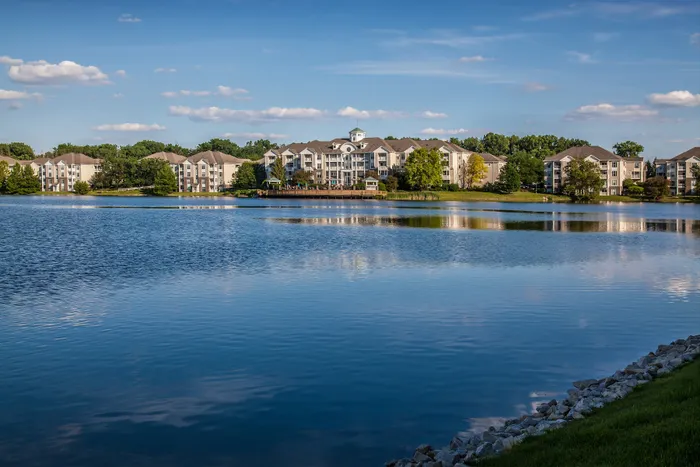Serene lakeside apartments with picturesque views and lush landscaping, perfect for peaceful living.
