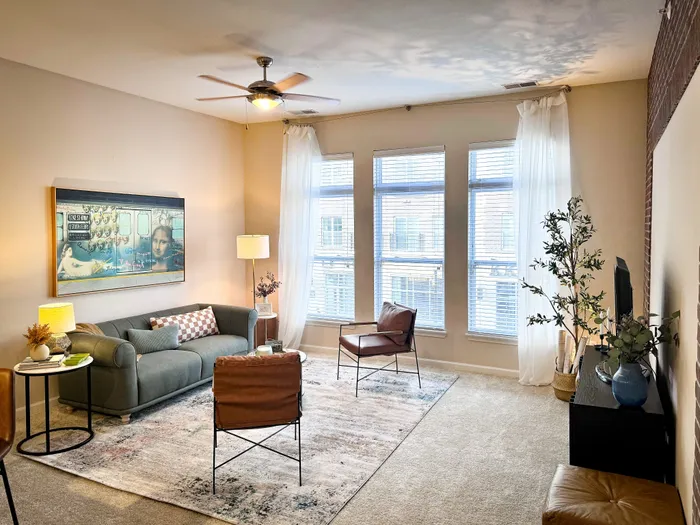 Bright and modern living room with large windows, perfect for relaxation and entertaining.