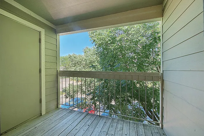 Inviting balcony with lush green views, perfect for relaxation in a serene setting.