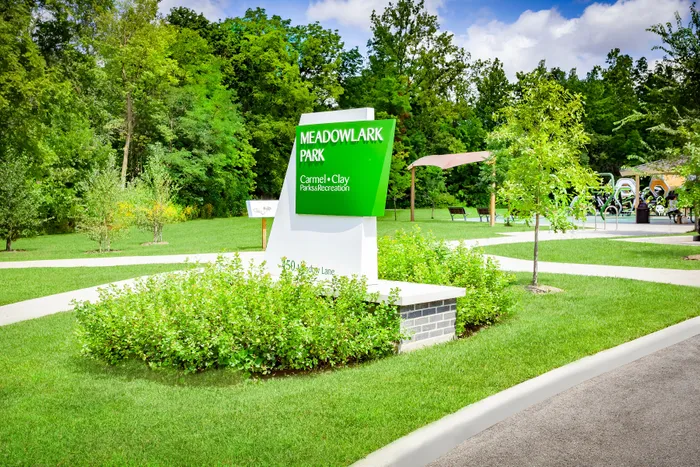 Vibrant Meadowlark Park entrance surrounded by lush greenery and a winding path, perfect for recreation and relaxation.