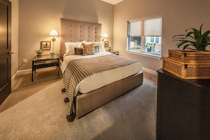 Inviting bedroom with plush bed, elegant lighting, and cozy atmosphere, perfect for relaxation.