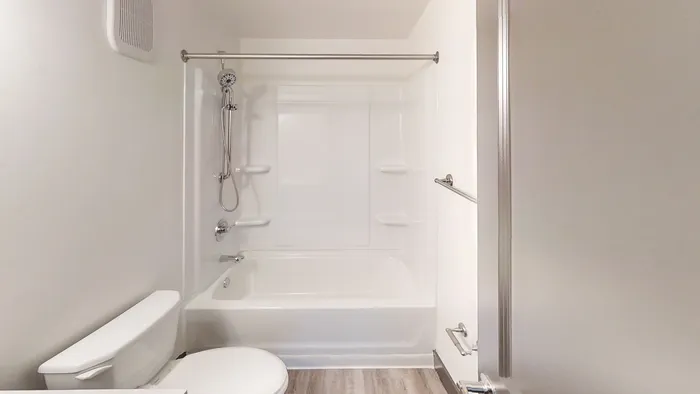 Modern bathroom with sleek white fixtures, elegant bathtub, and stylish showerhead, featuring a clean, minimalist design.
