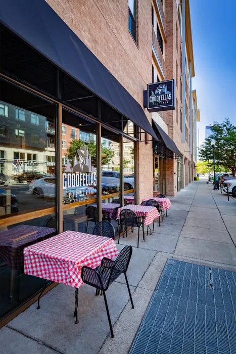 Charming sidewalk view of Goodfellas Pizzeria with inviting outdoor seating.