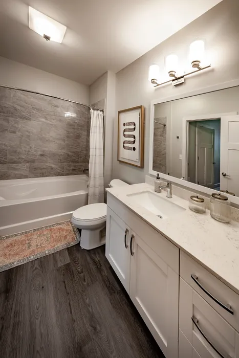 Elegant bathroom with stylish tile accents, modern vanity, and ambient lighting.
