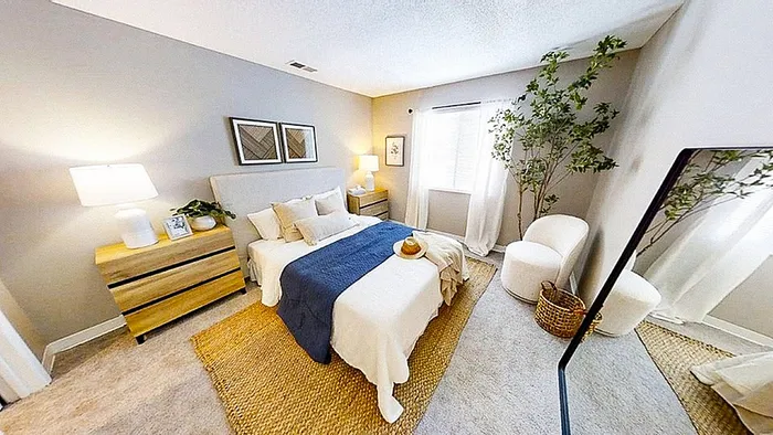 Inviting and stylish bedroom with modern decor, plush bed, elegant furnishings, and abundant natural light.