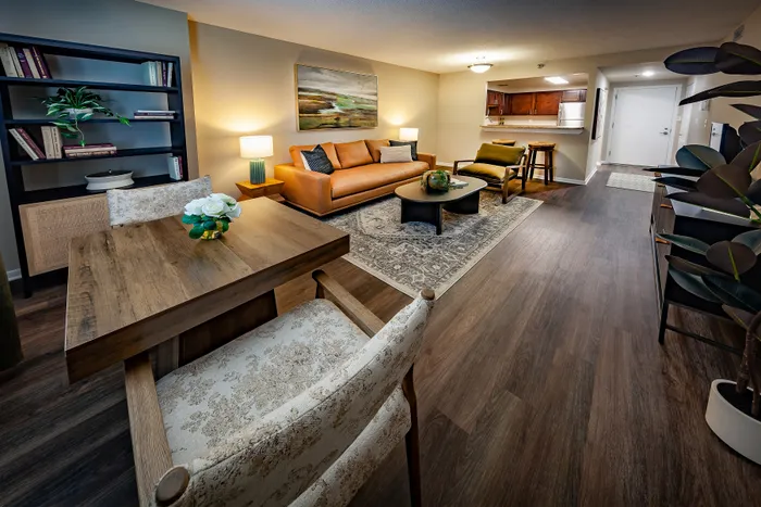 Inviting living space featuring a cozy sofa, elegant dining table, and a modern open kitchen.