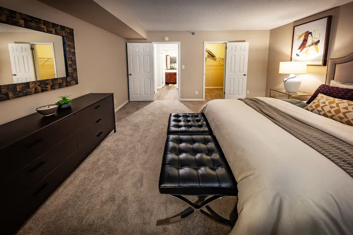 Luxurious bedroom with elegant decor, featuring a plush bed, stylish artwork, and modern furniture for a cozy retreat.