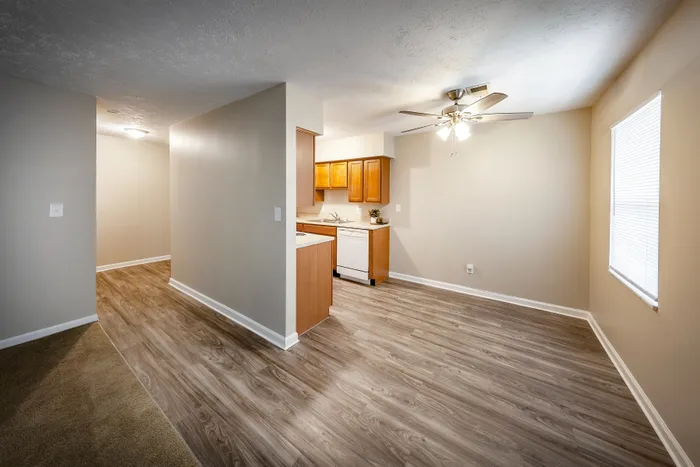 Main Street on the Monon Apartments - Bright and inviting kitchen with modern wood cabinets, sleek countertops, and stylish ceiling fan.