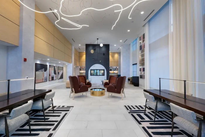 The Elex Apartments - Luxurious lounge area featuring elegant armchairs, modern lighting, and chic decor, creating a welcoming ambiance.