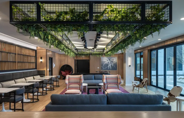 The Elex Apartments - Contemporary lounge with lush greenery, cozy seating, and chic decor, perfect for relaxation and social gatherings.
