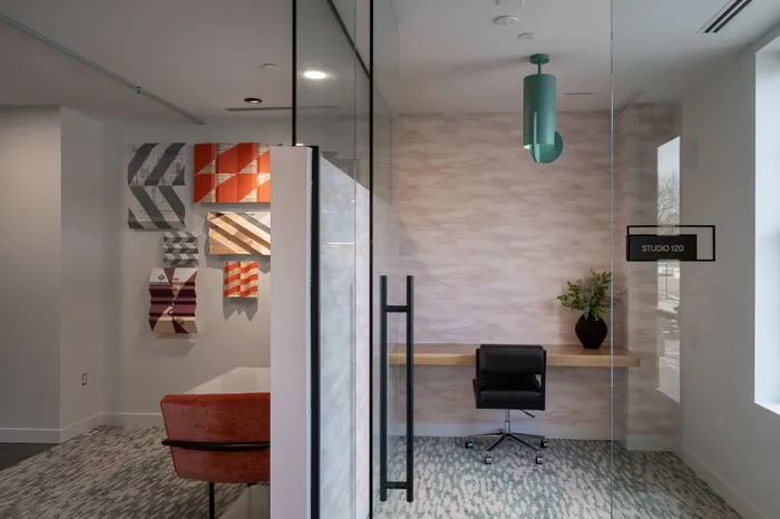 The Elex Apartments - Modern workspace featuring contemporary art, sleek furniture, and a minimalist design.