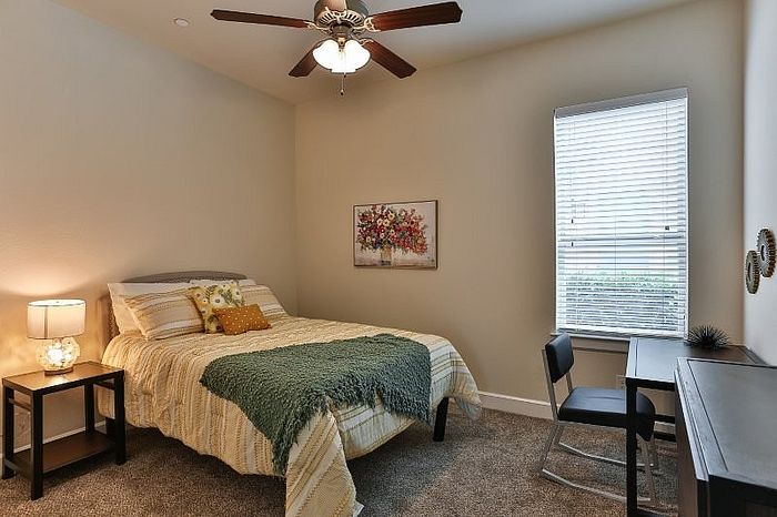 Inviting bedroom with warm lighting, cozy bed, and elegant decor, perfect for relaxation.