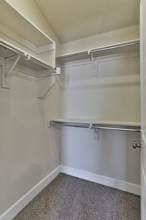 Spacious walk-in closet with ample shelving and hanging space, offering organizational ease and convenience.