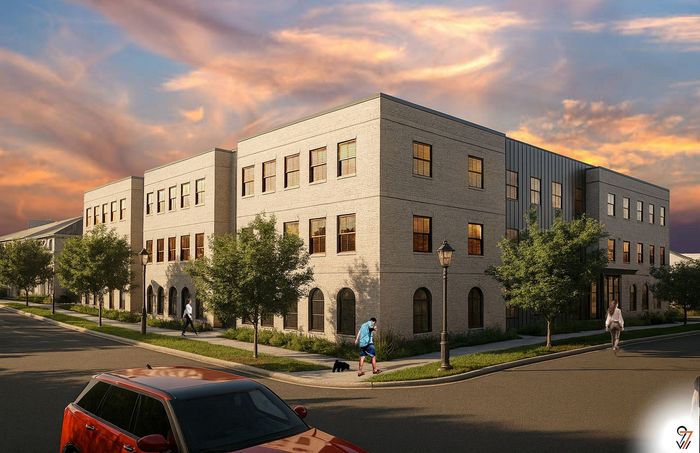Elegant three-story apartment building with classic architecture under a vibrant sunset sky.