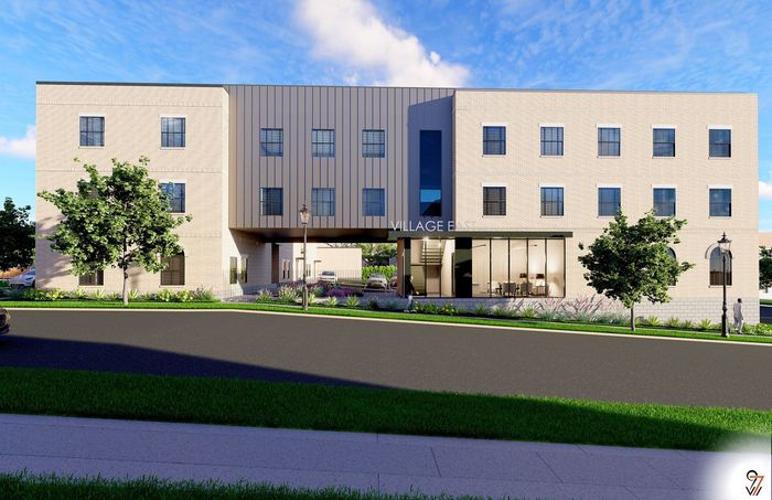 Modern apartment building with large windows and sleek architectural design at Village East, surrounded by lush greenery.