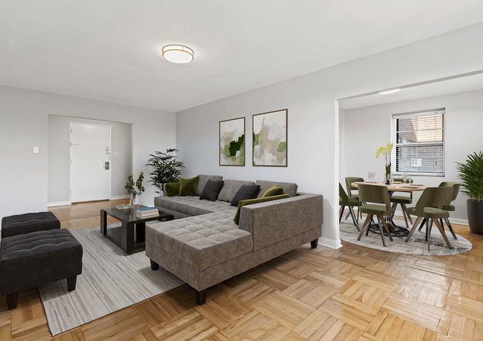 Spacious living room with a sleek gray sectional sofa, modern decor, and an adjacent dining area with green chairs.