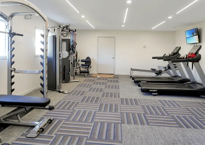 Bright and modern fitness center featuring state-of-the-art gym equipment and sleek design.
