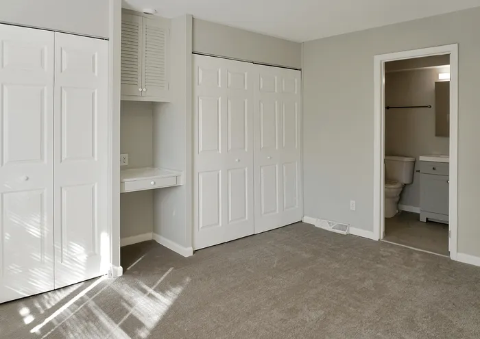 Bright bedroom with plush carpeting, large closets, and attached bathroom.
