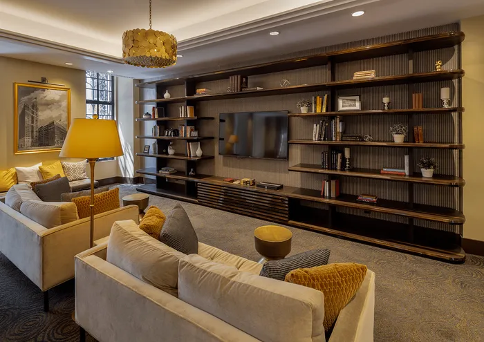 Beautifully designed living room with plush sofas, stylish shelving, and warm lighting.