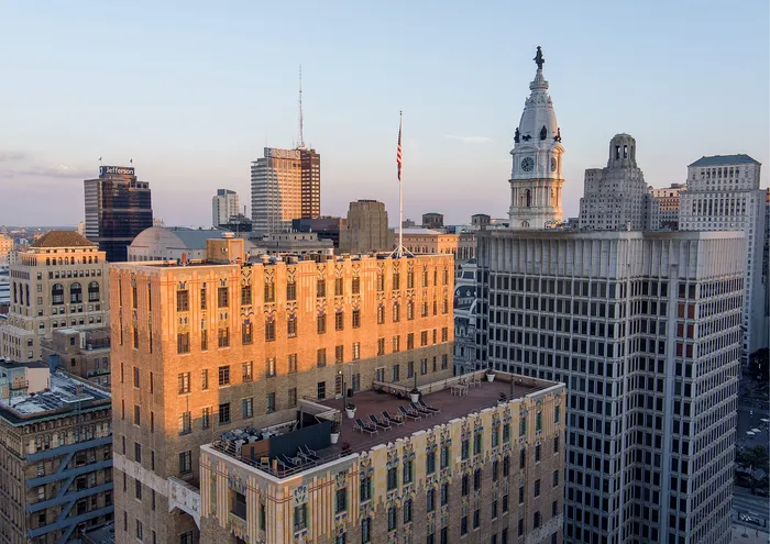 Stunning cityscape featuring historic architecture and modern skyscrapers at sunset.