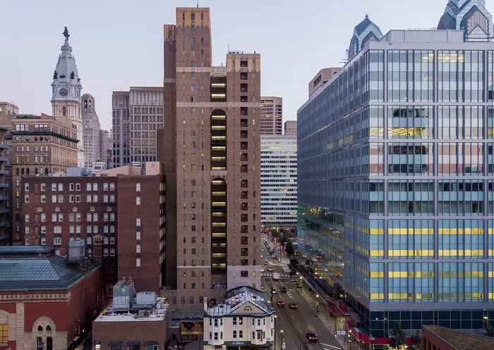 Vibrant downtown cityscape featuring historic and modern buildings at dusk.