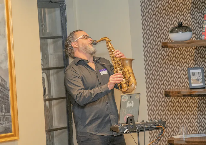 Chic apartment interior featuring a saxophonist performing near modern decor.