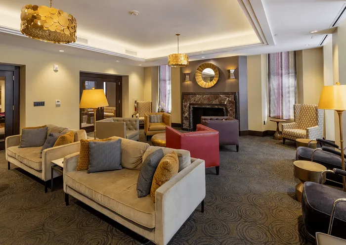 Sophisticated lounge with plush seating, ambient lighting, and a modern fireplace.