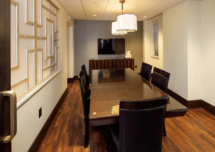 Chic dining room with a modern table, stylish chairs, and ambient lighting.