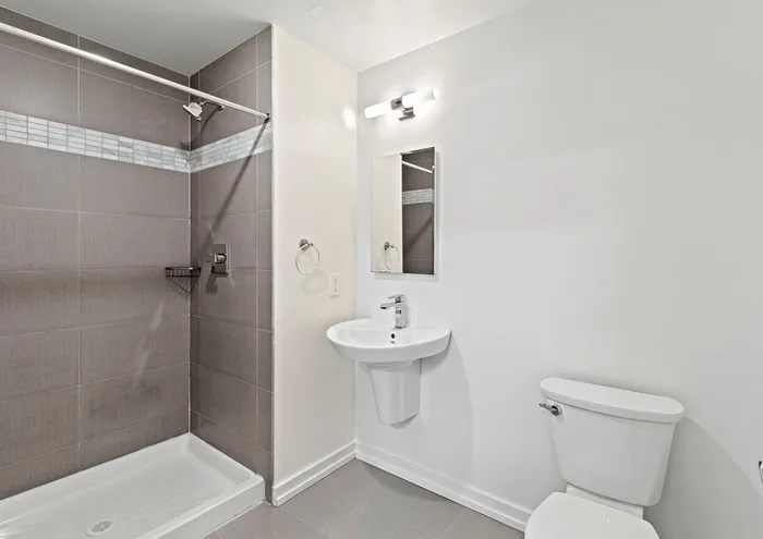 Stylish bathroom with contemporary design featuring a sleek shower, elegant sink, and modern fixtures.