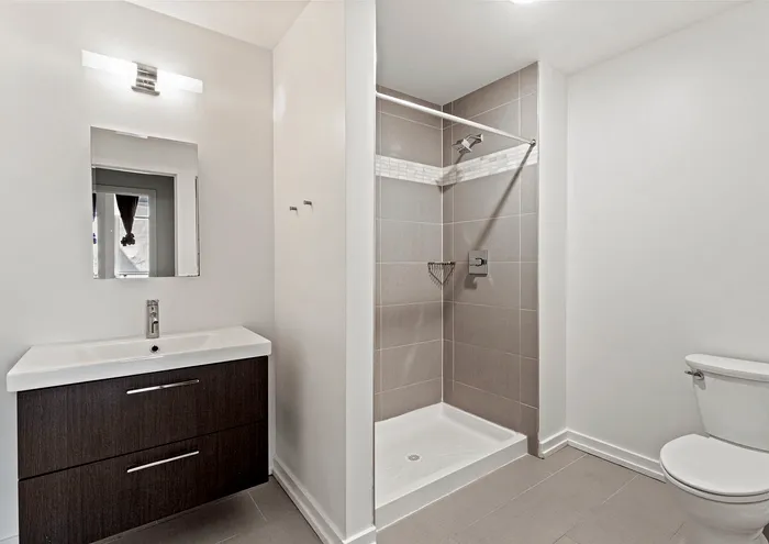 Chic bathroom with a sleek vanity, modern shower, and contemporary fixtures.