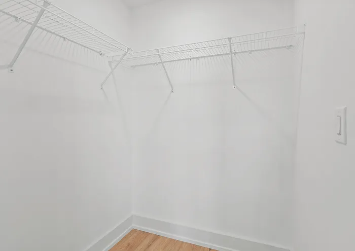 Bright and clean walk-in closet with ample shelving space.