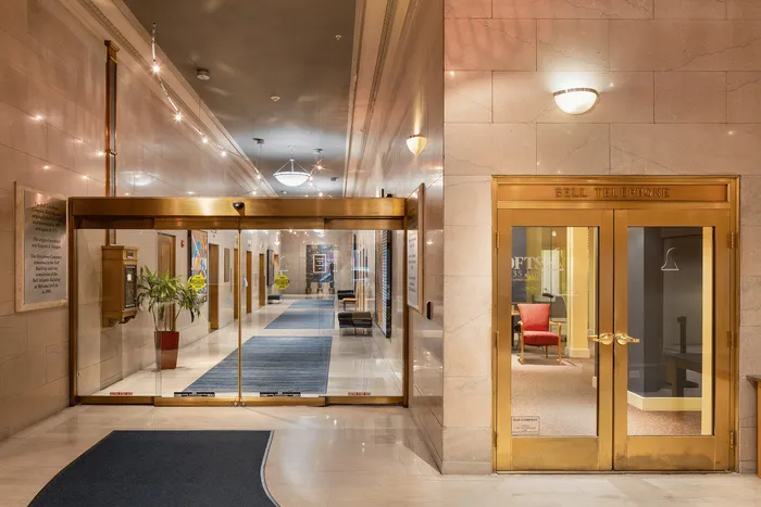 Elegant and spacious hallway with polished marble walls, warm lighting, and charming vintage details, offering a welcoming entrance.