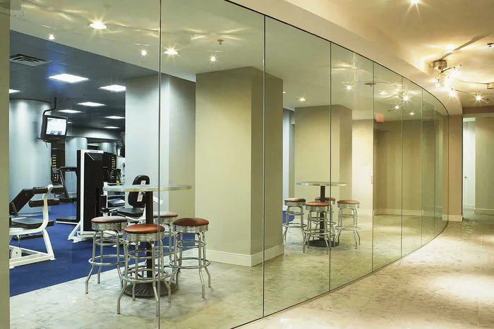 Elegant fitness center with sleek design, mirrored walls, and modern gym equipment.