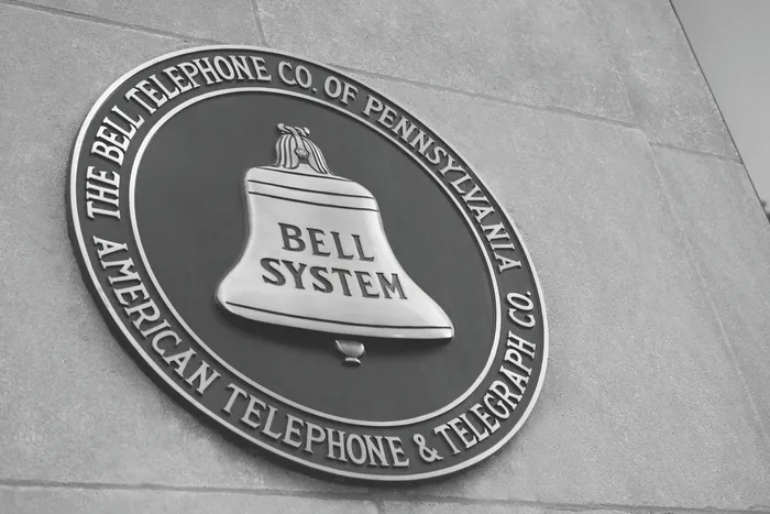 Historic Bell System plaque on a concrete wall, symbolizing vintage telecommunications heritage.