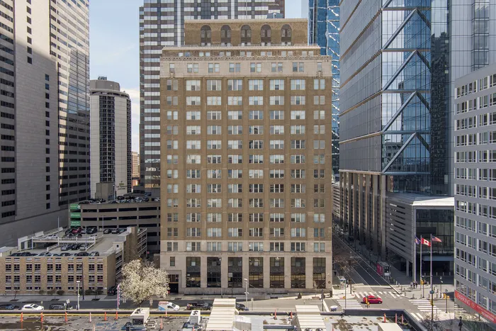 Historic mid-rise apartment building nestled in a vibrant urban landscape, offering classic charm and modern convenience.